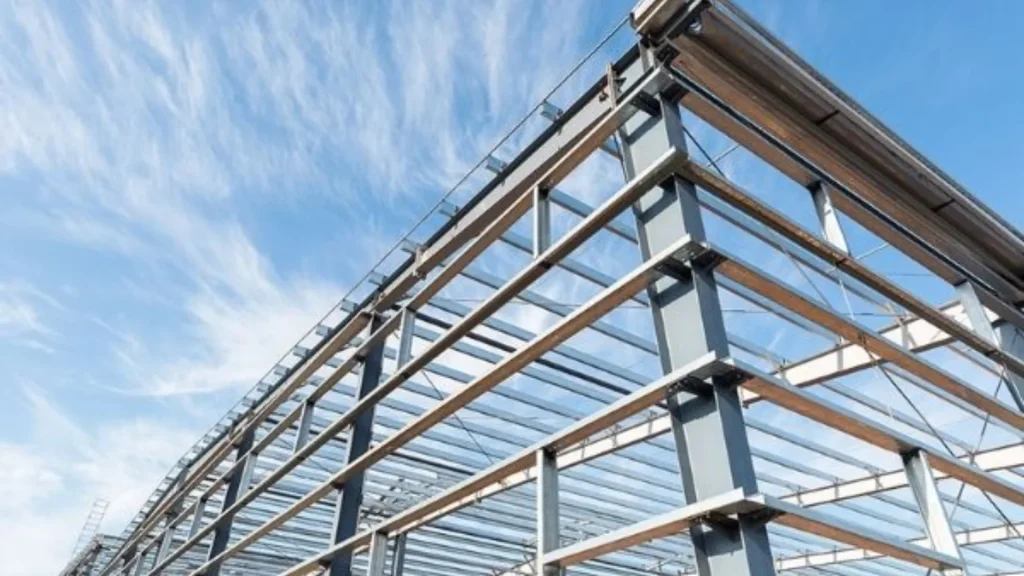 Steel framework of a construction project under a blue sky, highlighting structural steel beams and supports, emphasizing strength and durability in building design.