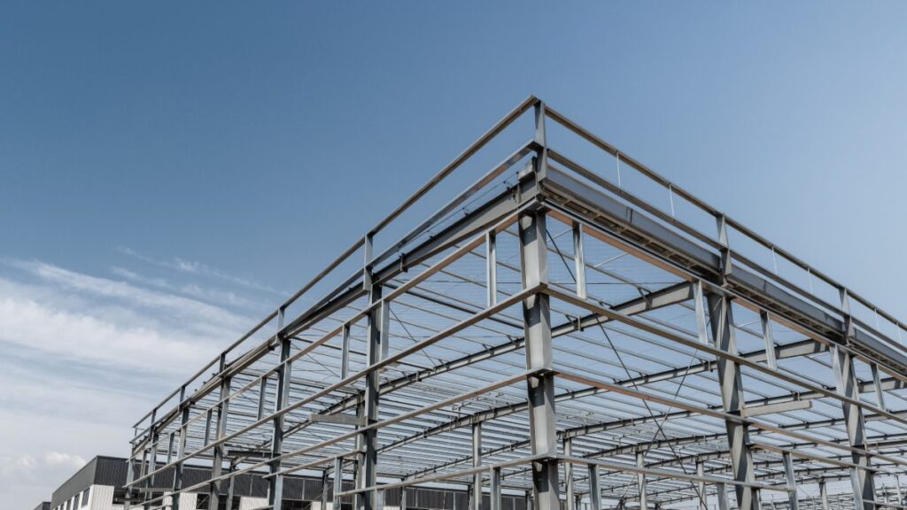 Steel frame construction of a modern building under a clear blue sky, showcasing structural steel elements relevant to Oklahoma's construction needs.